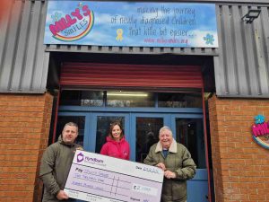 Councillor Smithson, Lorraine Hargreaves and Councillor Britcliffe holding giant cheque