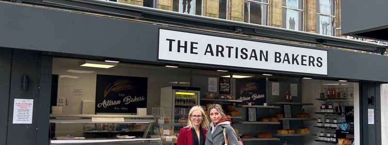 2 people stood in front of The Artisan Baker stall