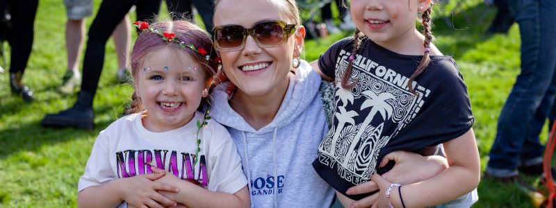 A woman and two children smiling at the camera