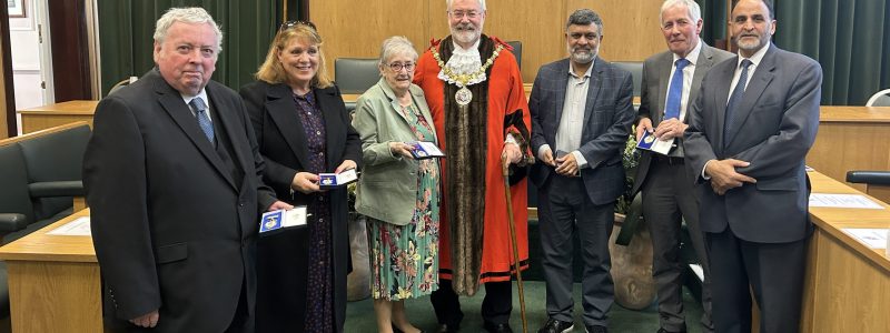 Seven people in formal wear including Mayor. Hyndburn Borough Council