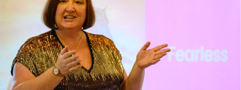 Presenter with screen in background