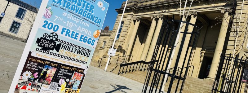 An Easter Extravaganza sign on a post outside the Mercer Hall building