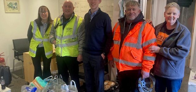 5 people with food donation in foreground