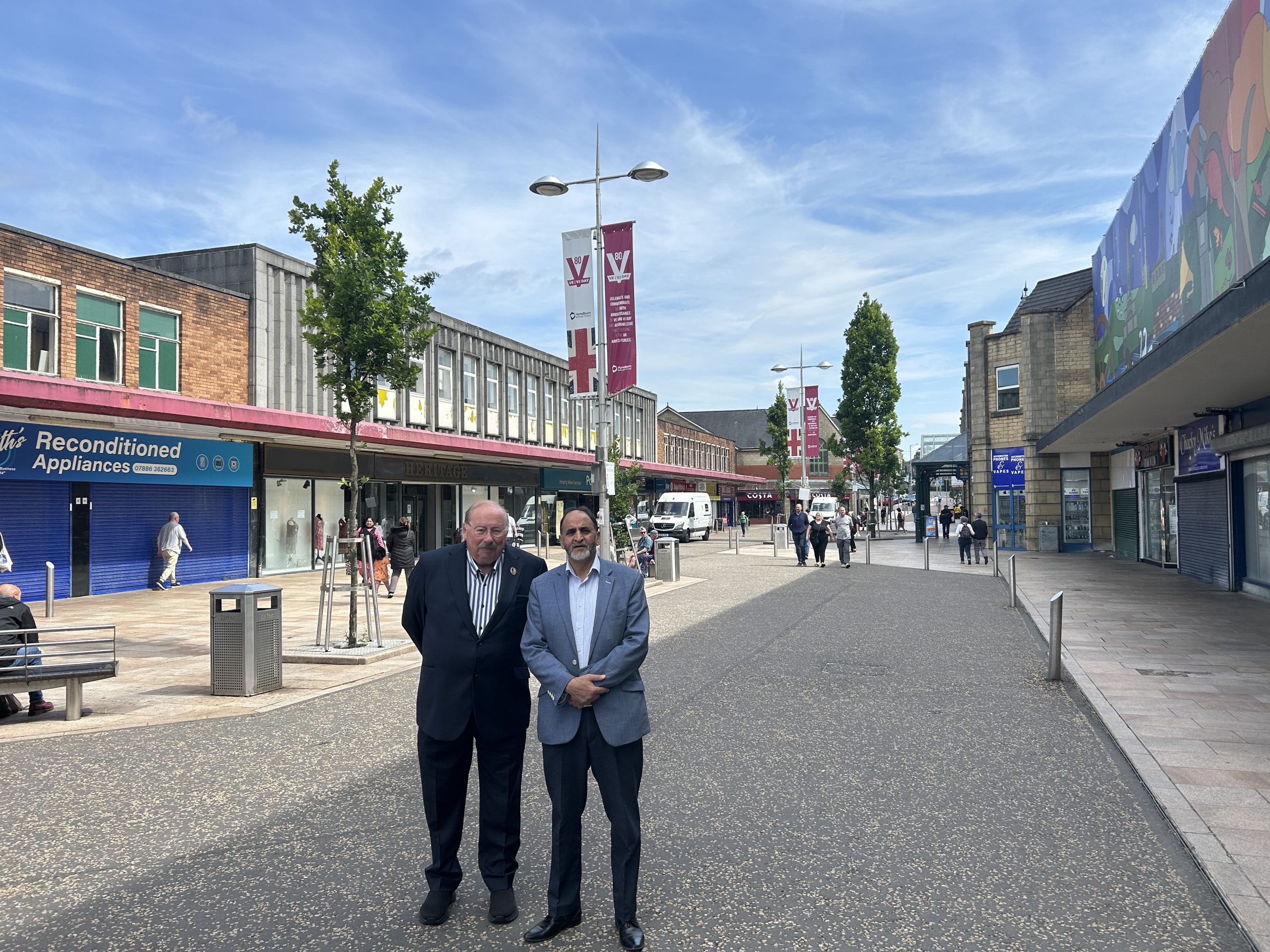 Two people standing on a high street