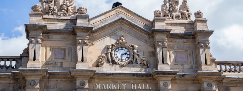 Market Hall including clock and stone sculptures