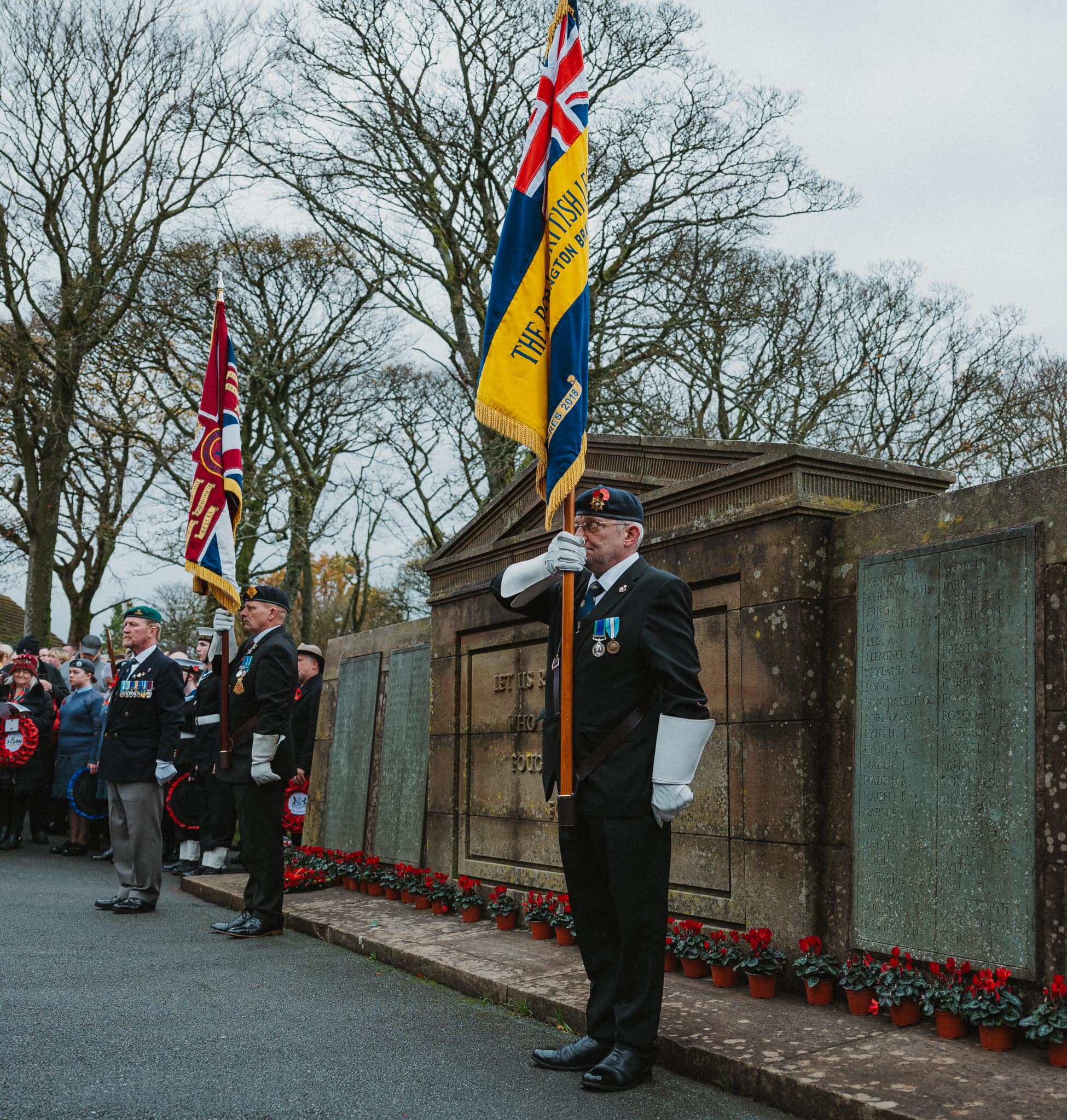 Flag bearers at a war memorial