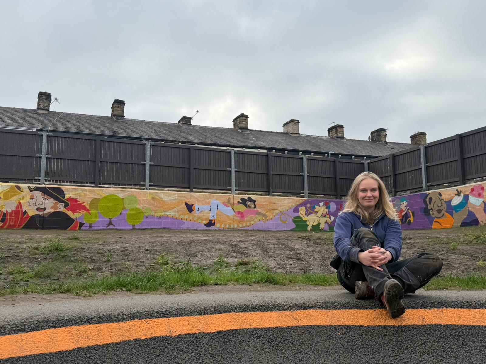 person sitting in front of art mural