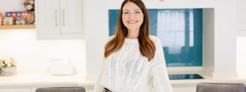 Person smiling in front of screen