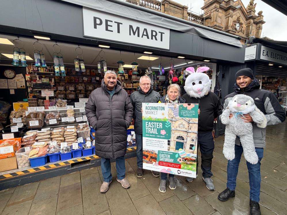 People holding a sign and dressed in easter costume outside pet mart