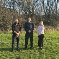 Three people in a field