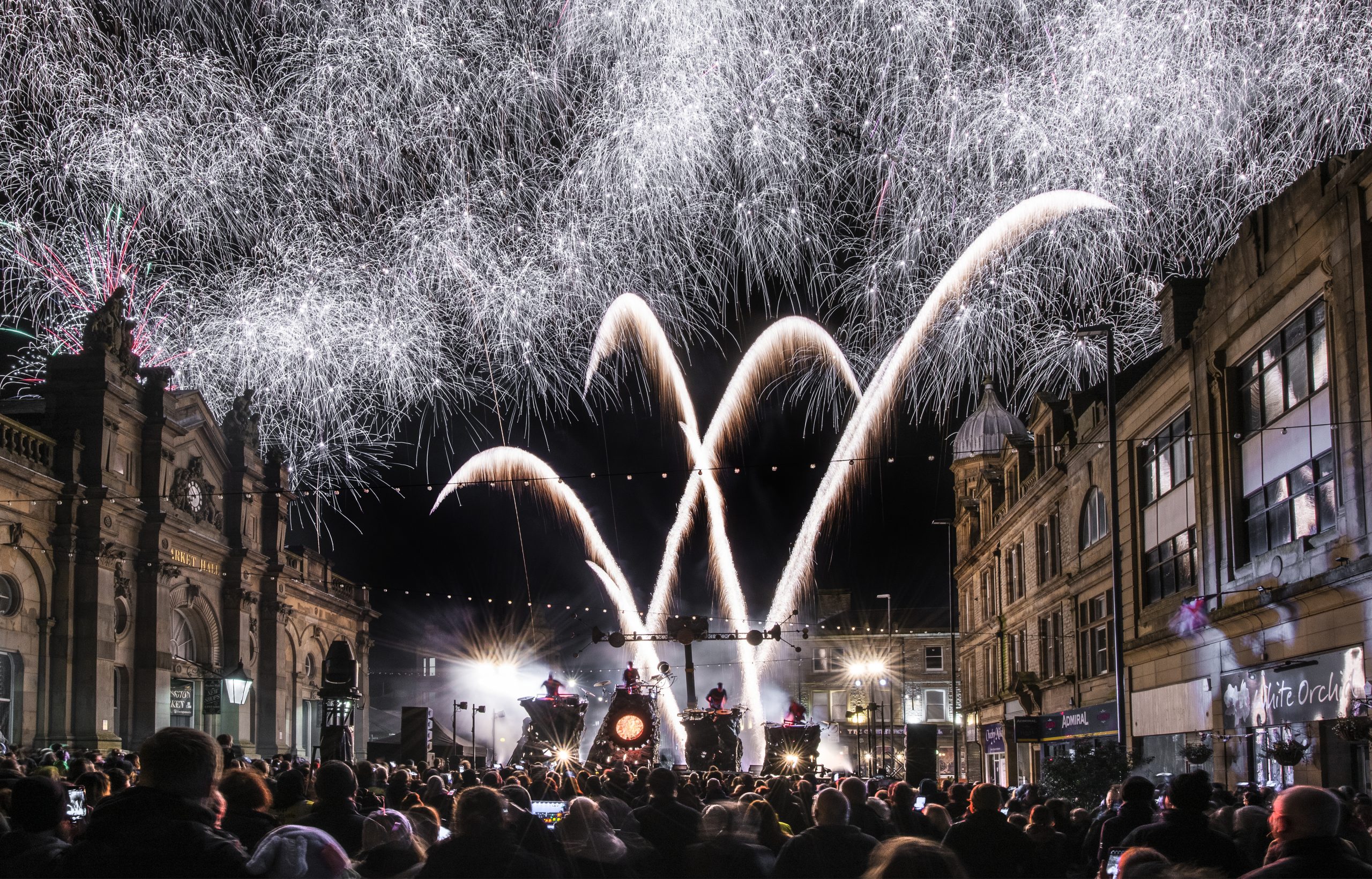 drummers on a stage with fireworks and lights