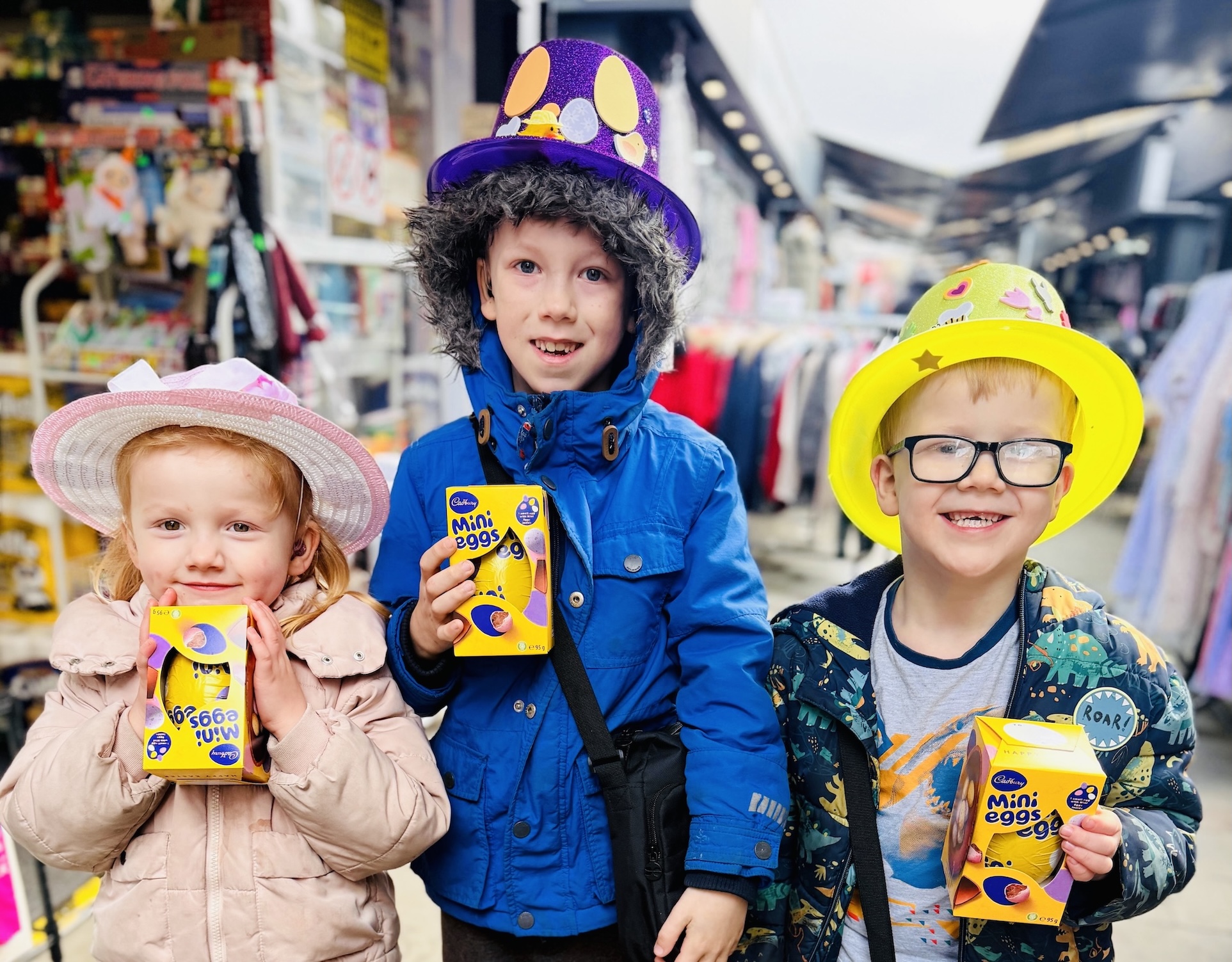 Three children holding Easter eggs