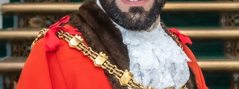 Person in ceremonial robes wearing a chain of office.
