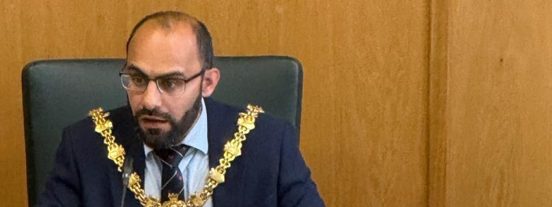 A Mayor sitting at a desk