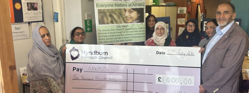 Several people holding a giant cheque