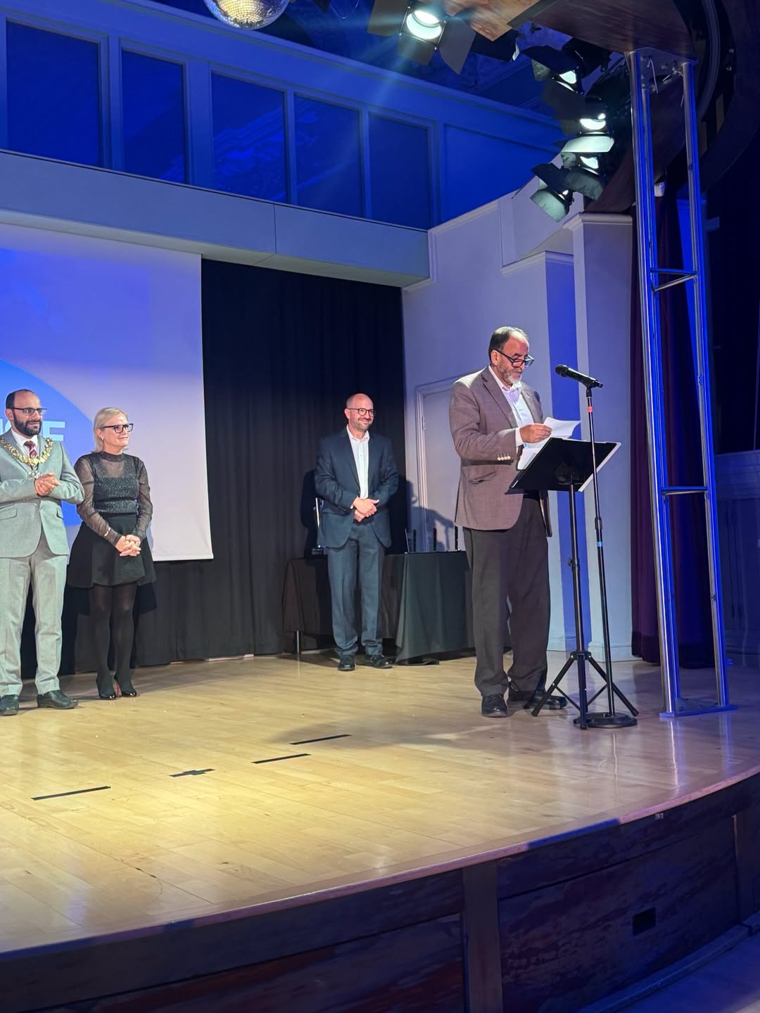 Person on a stage making an announcement